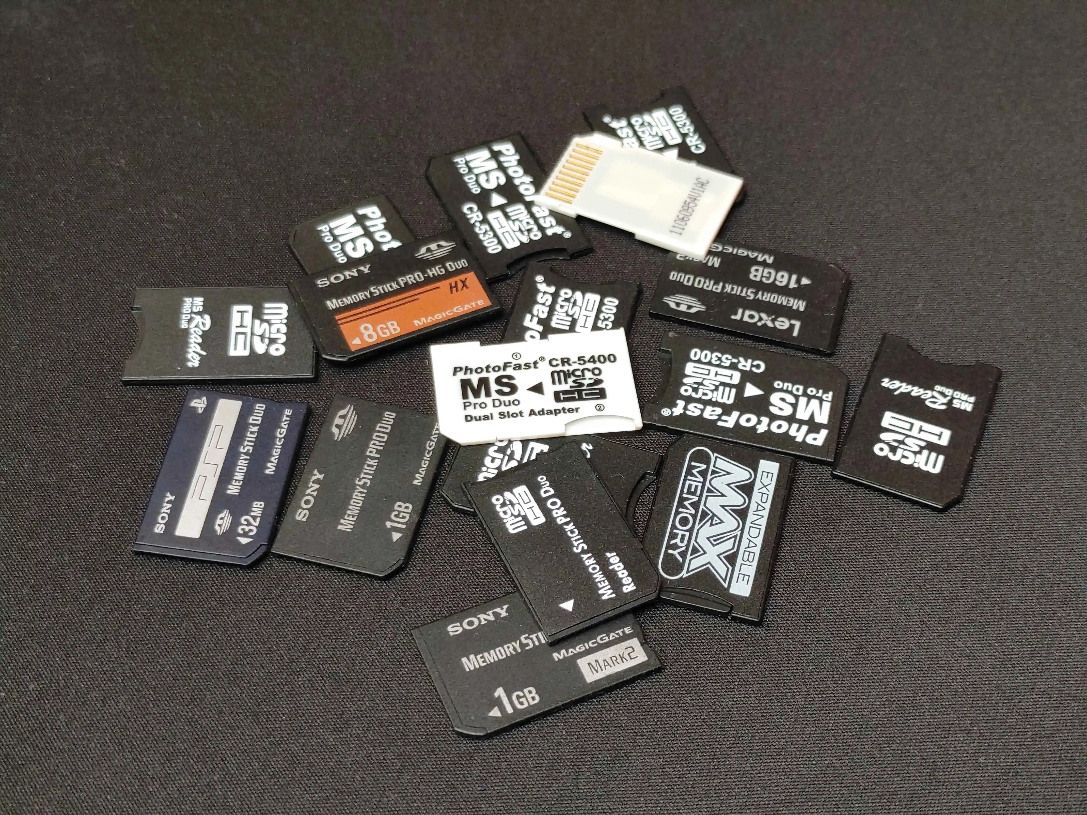 pile of memory stick pro duo cards and adapters